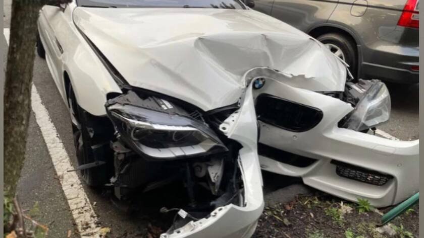 Driver checking vehicle damage after a car accident in Methuen, MA